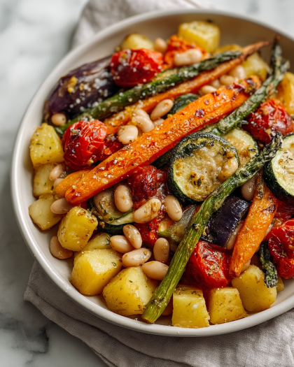 Roasted Vegetables with White Beans and Herb DressingA colorful assortment of roasted vegetables—carrots, zucchini, potatoes, tomatoes, green beans—tossed with creamy white beans and a light herb-infused dressing for a hearty vegetarian main or side dish.  Why You’ll Love This Recipe  This dish is rustic, nourishing, and full of flavor. The roasted vegetables offer a natural sweetness and depth, while the white beans provide protein and heartiness. It’s equally delicious warm or at room temperature and easy to prep ahead.  ingredients  (Tip: You can find the complete list of ingredients and their measurements in the recipe card below.) • Carrots • Zucchini • Cherry tomatoes • Red onion • Baby potatoes • Green beans • Olive oil • Salt and black pepper • Dried thyme or Italian seasoning • Canned white beans (cannellini or great northern), drained and rinsed • Fresh parsley or basil (optional)  directions  Preheat oven to 425°F (220°C). Chop vegetables into even-sized pieces. Toss with olive oil, salt, pepper, and dried herbs. Spread on a baking sheet in a single layer. Roast for 30–35 minutes, turning halfway through, until vegetables are tender and golden. Toss warm vegetables with white beans and fresh herbs before serving.  Servings and timing  Serves 4 as a main or 6 as a side. Prep time: 15 minutes. Cook time: 35 minutes.  Variations  • Add bell peppers, mushrooms, or eggplant for variety. • Drizzle with balsamic glaze or lemon juice before serving. • Serve over couscous, quinoa, or polenta for a full meal.  storage/reheating  Store in the refrigerator for up to 4 days. Reheat in the oven or a skillet for best texture. Freezing is not recommended, as vegetables may become mushy.  FAQs Can I use dried beans instead of canned?  Yes, just cook and cool them before adding to the roasted vegetables.  Should I peel the potatoes or carrots?  It’s not necessary, but you can peel them if preferred. Scrub thoroughly beforehand.  How do I ensure the vegetables roast evenly?  Cut them into uniform sizes and don’t overcrowd the pan.  Can I add protein to make it a full meal?  Yes, grilled chicken, tofu, or halloumi pair well.  What’s the best oil for roasting?  Olive oil is ideal, but avocado oil or grapeseed oil are also good options.  Can I make this ahead of time?  Yes, roast the vegetables and store them separately from the beans, then reheat and combine before serving.  Is this dish vegan?  Yes, as long as no cheese or non-vegan dressing is added.  Can I serve this cold as a salad?  Yes, it’s delicious at room temperature or chilled, especially with a light vinaigrette.  Can I use frozen vegetables?  Fresh is best for roasting, but frozen vegetables can be used if thawed and patted dry.  What herbs taste best with this dish?  Fresh parsley, basil, or thyme add brightness to the earthy flavors.  Conclusion  Packed with vibrant vegetables and wholesome beans, this roasted medley is a versatile, nutritious, and delicious dish that’s perfect for any season—serve it warm, cold, or as a centerpiece for meatless meals.